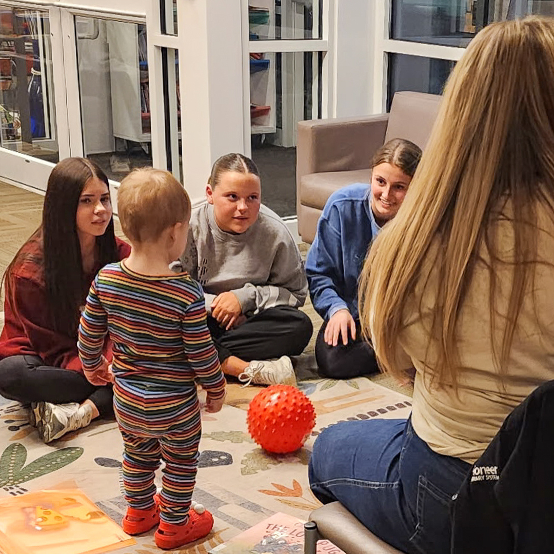 Girls listen to someone read