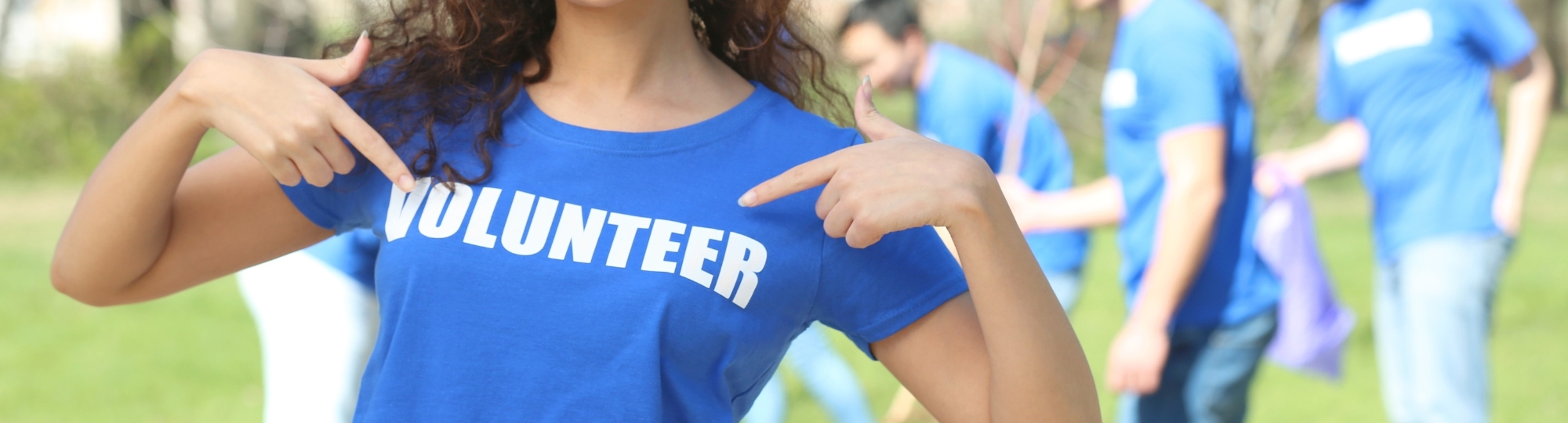Person wearing a shirt that says volunteer