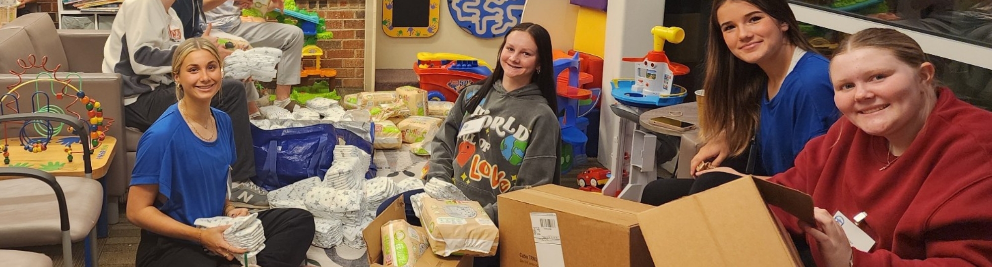 Students packing diapers